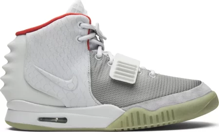 The Air Yeezy 2 NRG 'Pure Platinum' launched in June 2012 featuring a subdued colorway that blends varying shades of grey on the upper and a contrasting pop of bright red on the collar lining.